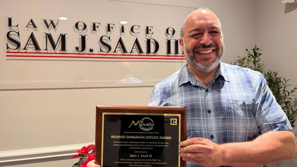 Sam-J-Saad-Marco-Island-Award Attorney Sam J Saad III holding his Richard Shanahan Service Award